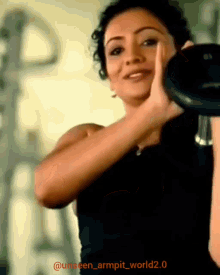 a woman lifting a dumbbell in a gym with the hashtag unseen_armpit_world2.0 on the bottom