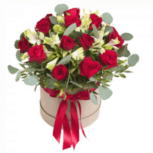 a round box filled with red roses and white lilies