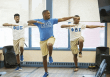 a man in a blue fbs shirt is dancing