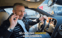 a man sitting in a car with the words so und das mindest muss stimmen above him