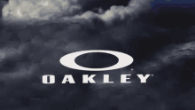 the oakley logo is against a dark cloudy sky