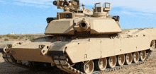 a military tank is parked in the dirt with a blue sky behind it