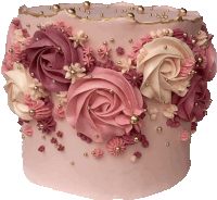 a pink cake decorated with pink and purple frosting and gold beads