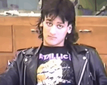 a young man wearing a black shirt that says metallica