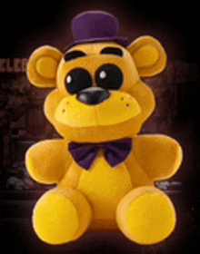 a yellow teddy bear with a purple hat and bow tie .