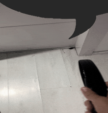 a person is holding a remote control in front of a door