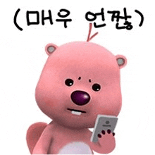 a pink teddy bear is holding a cell phone in its paws .