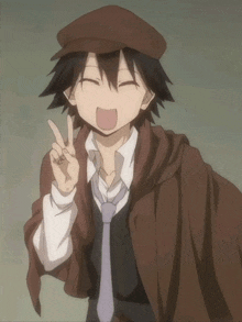 a young man wearing a hat and tie giving a peace sign