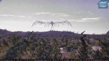 a picture of a monster flying over a forest with a blue sign that says image paradise post