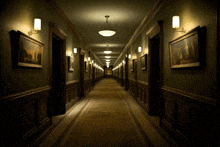 a long hallway with a few paintings on the wall