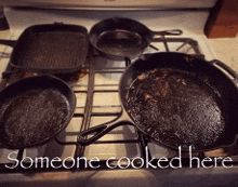 someone cooked here is written on a stove with dirty pans