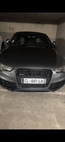 a gray audi with a license plate that says cl-841-la