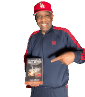 a man wearing a la hat is pointing to a book titled 10 strategies to take action