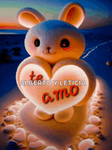 a stuffed rabbit holding a heart that says " te alberto y leticia amo "