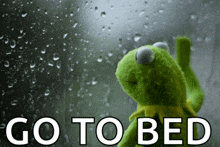 kermit the frog is looking out a window with the words go to bed written below him