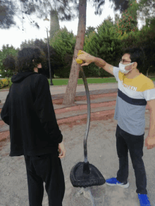 a man wearing a shirt that says taken is standing next to another man wearing a mask