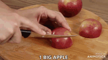 a person is cutting an apple on a wooden cutting board with the words " 1 big apple " on the bottom