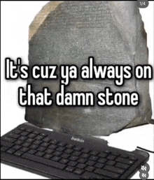 a belkin keyboard sits next to a large rock and says it 's cuz ya always on that damn stone