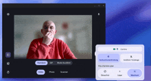 a computer screen shows a man in a red sweater covering his mouth with his hands