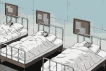 three hospital beds are lined up in a room with bulletin boards