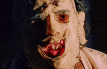 a close up of a person 's face with a bloody mouth and teeth