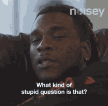 a man laying on a couch with the words " what kind of stupid question is that " on the bottom