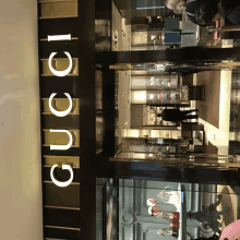 a store front of a gucci store with mannequins