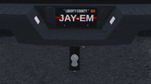 a black truck with a liberty county tag that says jay-em