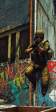 a soldier is holding a gun in front of a wall with graffiti