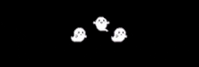 a group of ghosts are flying in the air on a black background .