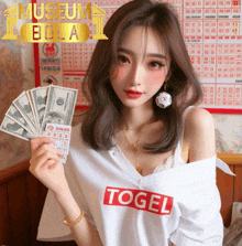 a woman wearing a white shirt with the word togel on it