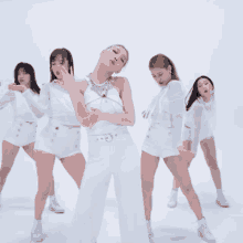 a group of women in white outfits are dancing in front of a white background