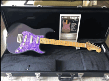 a purple electric guitar in a case that says " chunky "