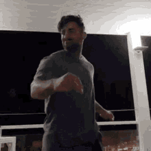 a man is dancing on a balcony at night