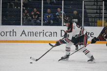 a hockey player with the number 9 on his jersey is skating on the ice