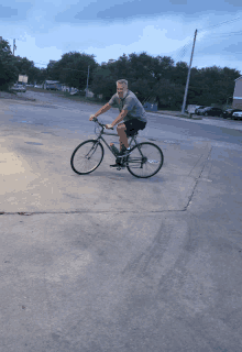 a man with a beard is riding a bike on a concrete surface