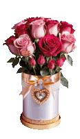 a bouquet of pink roses in a white box with a heart shaped decoration