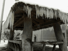 icicles hang from the roof of a gazebo