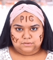 a woman with pig written on her forehead