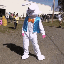 a person dressed as an easter bunny is standing in front of a sign that says ' linen building '