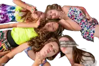 a group of girls are laying in a circle on the floor