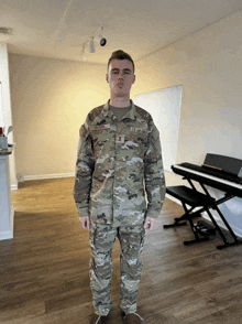 a man in a us army uniform is standing in a living room