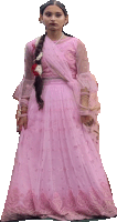 a woman in a long pink dress is standing