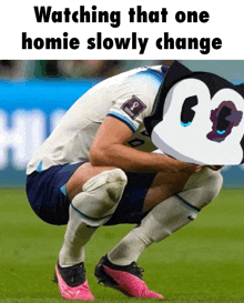 a soccer player is squatting down on the field with a mickey mouse hat on his head