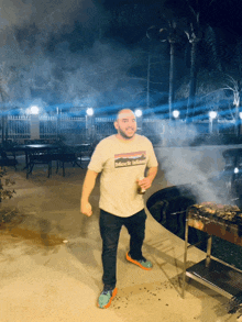 a man wearing a patagonia t-shirt is holding a beer