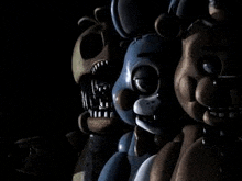 a group of five nights at freddy 's stuffed animals are standing next to each other in the dark .