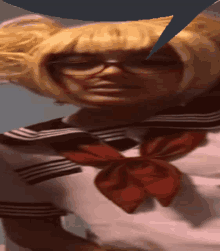 a woman with blonde hair and glasses is wearing a sailor outfit