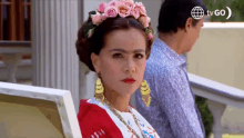 a woman in a frida kahlo costume is standing next to a man