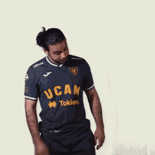 a man wearing a shirt that says ucam on it