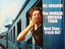 a woman covering her mouth while looking out the window of a train